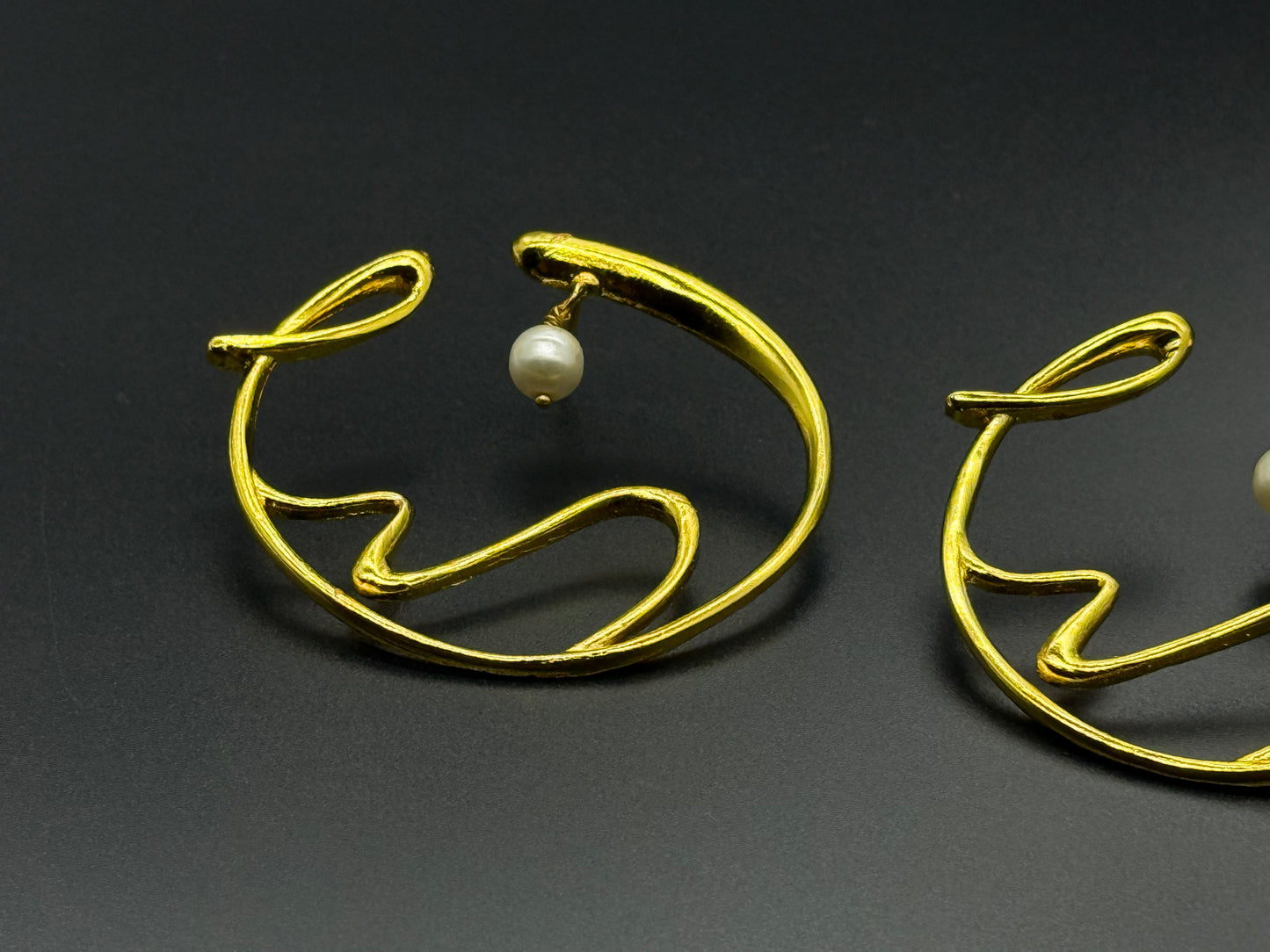 Golden Wave Brass Earrings with Pearl Drop – Modern Art-Inspired Statement Jewelry