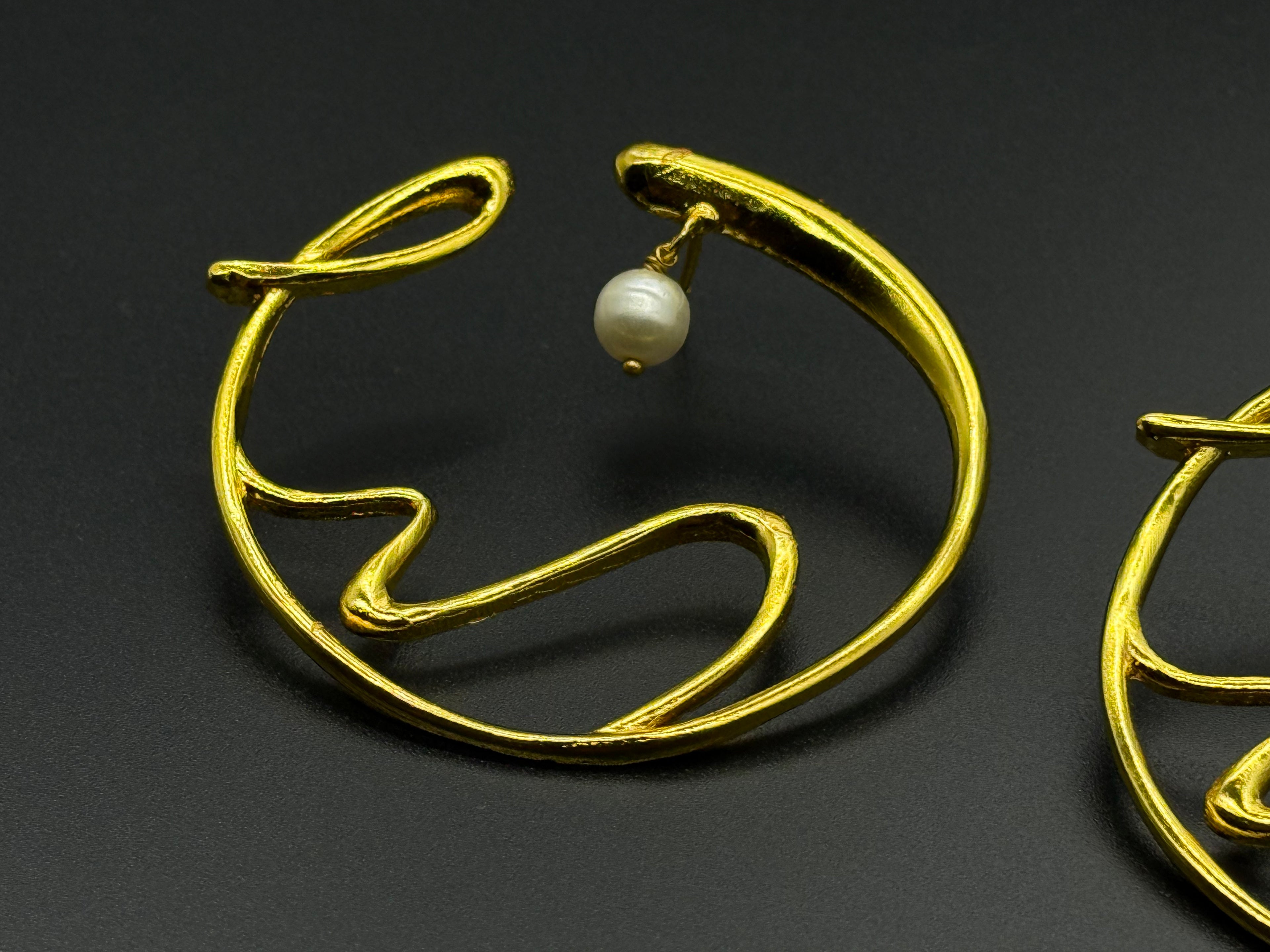 Golden Wave Brass Earrings with Pearl Drop – Modern Art-Inspired Statement Jewelry